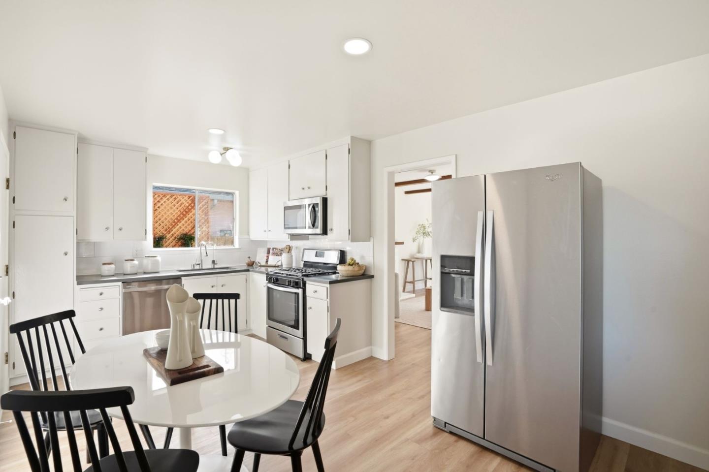 882 San Rafael Avenue Mountain View, CA 94043 - Photo 17 of 50 a kitchen with a table chairs refrigerator and microwave