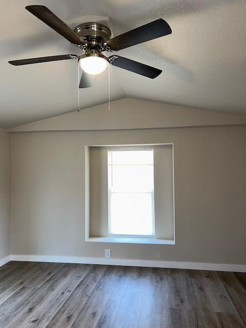 6135 Robin Road Crestview, FL 32539 - Photo 12 of 24 a view of an empty room with wooden floor and a window