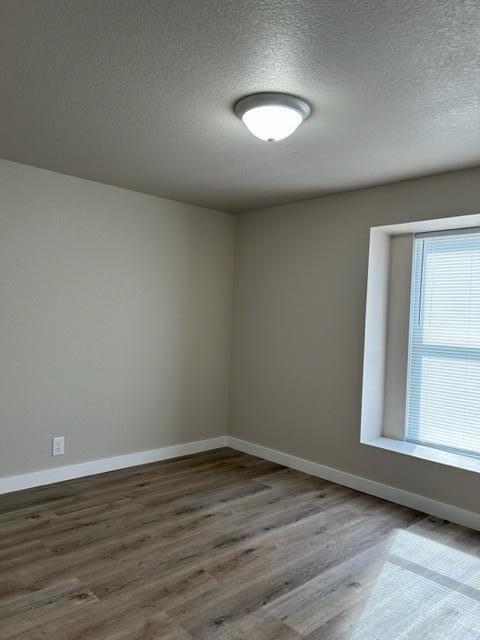 6135 Robin Road Crestview, FL 32539 - Photo 18 of 24 an empty room with wooden floor and windows