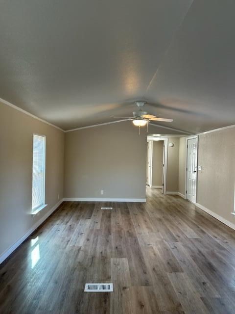 6135 Robin Road Crestview, FL 32539 - Photo 2 of 24 an empty room with wooden floor and windows