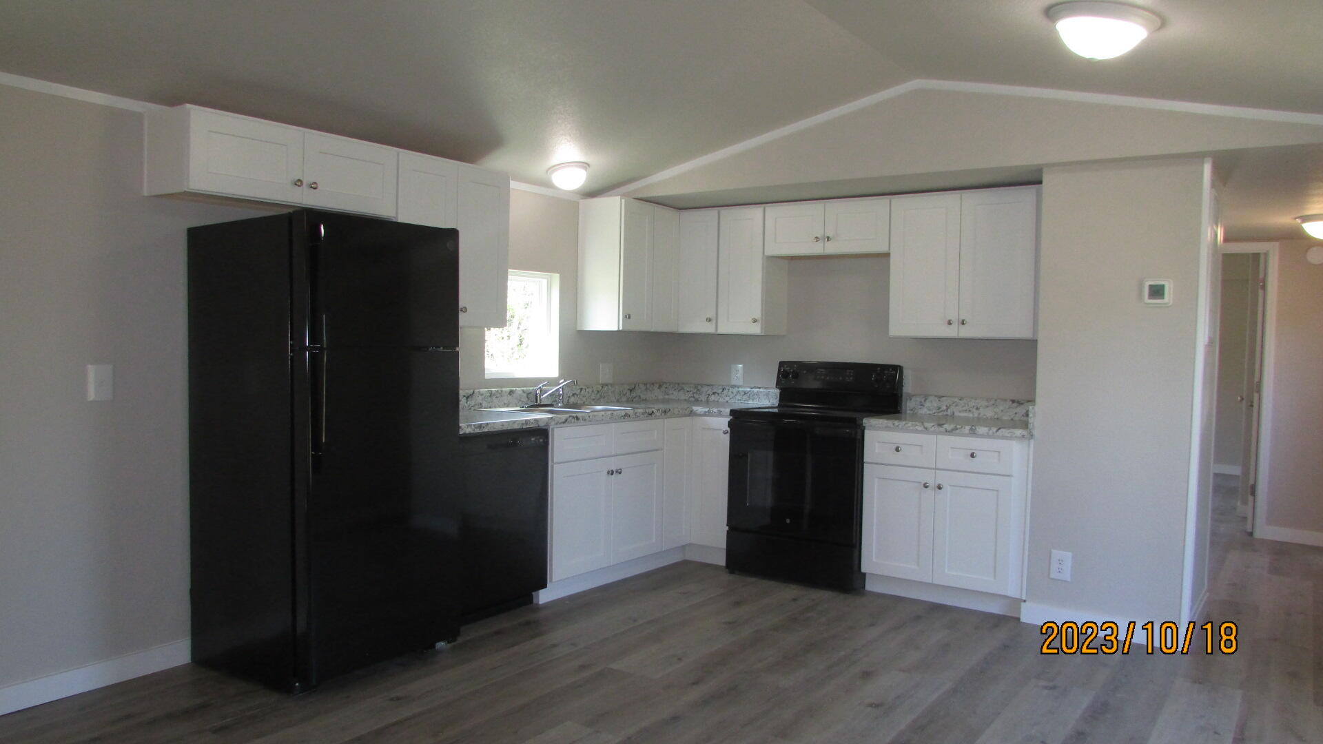 6135 Robin Road Crestview, FL 32539 - Photo 4 of 24 a kitchen with a refrigerator and a stove top oven