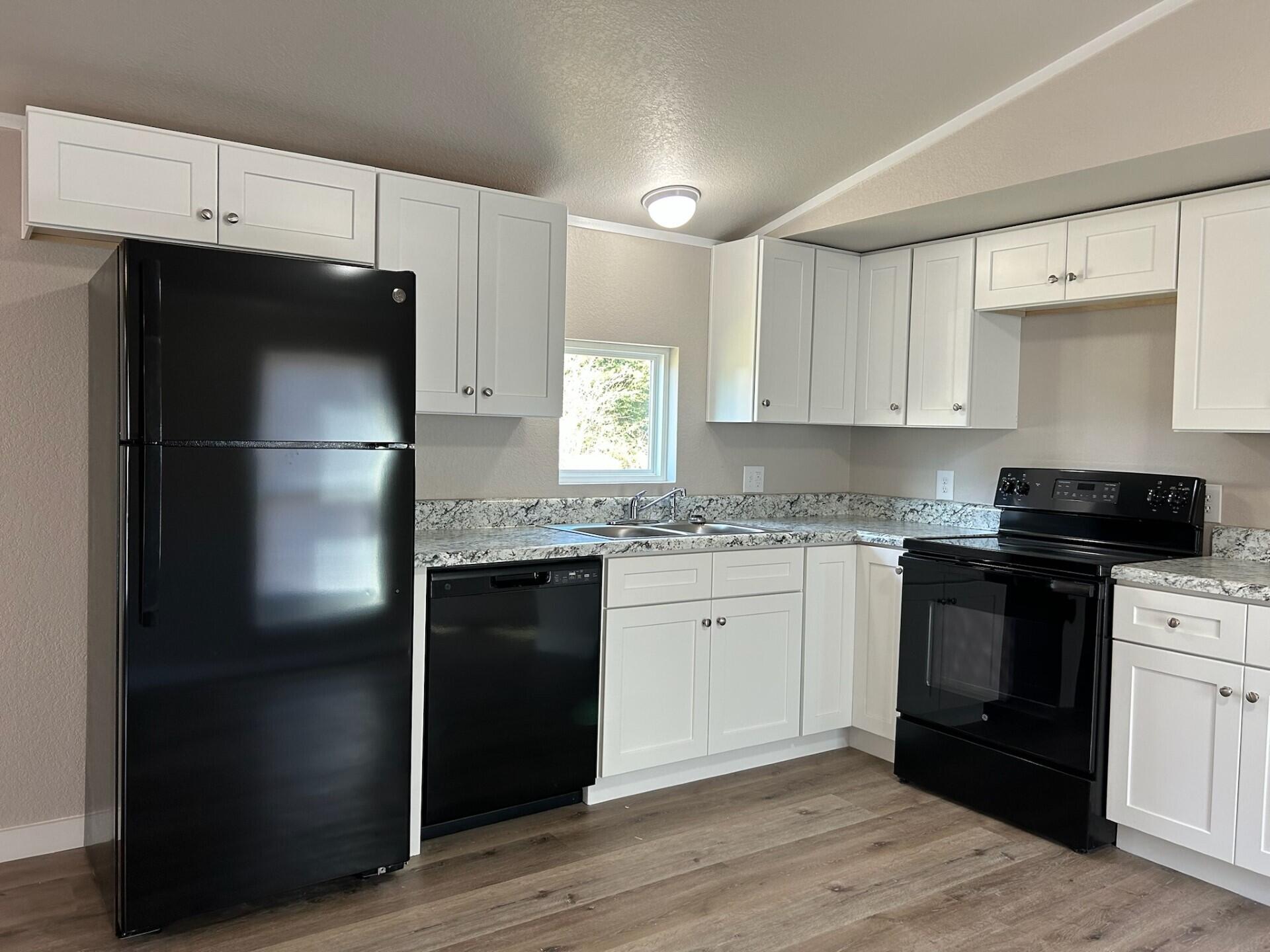 6135 Robin Road Crestview, FL 32539 - Photo 5 of 24 a kitchen with a refrigerator and a stove top oven