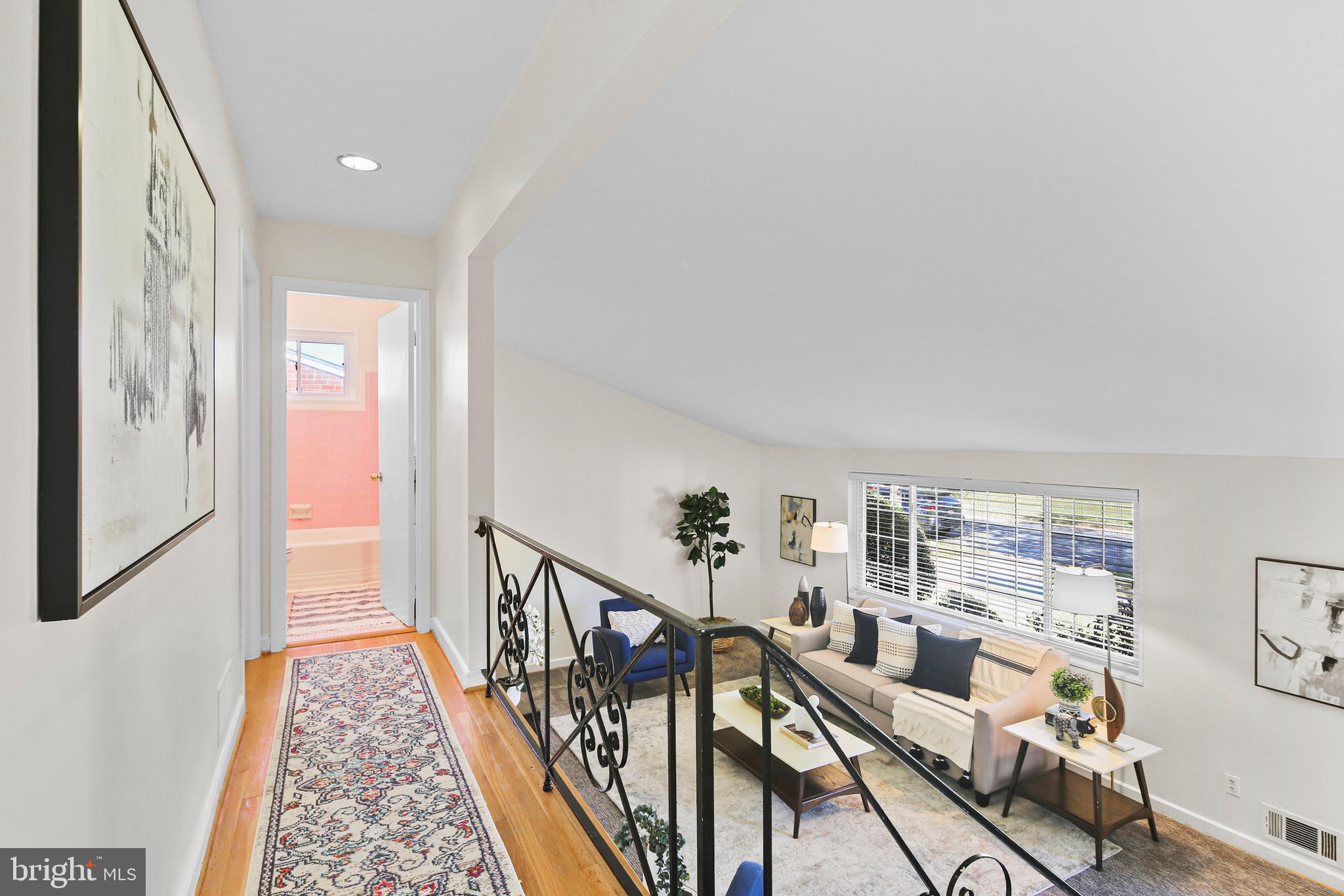 12910 Crisfield Road Silver Spring, MD 20906 - Photo 13 of 30 a view of a hallway with wooden floor and windows
