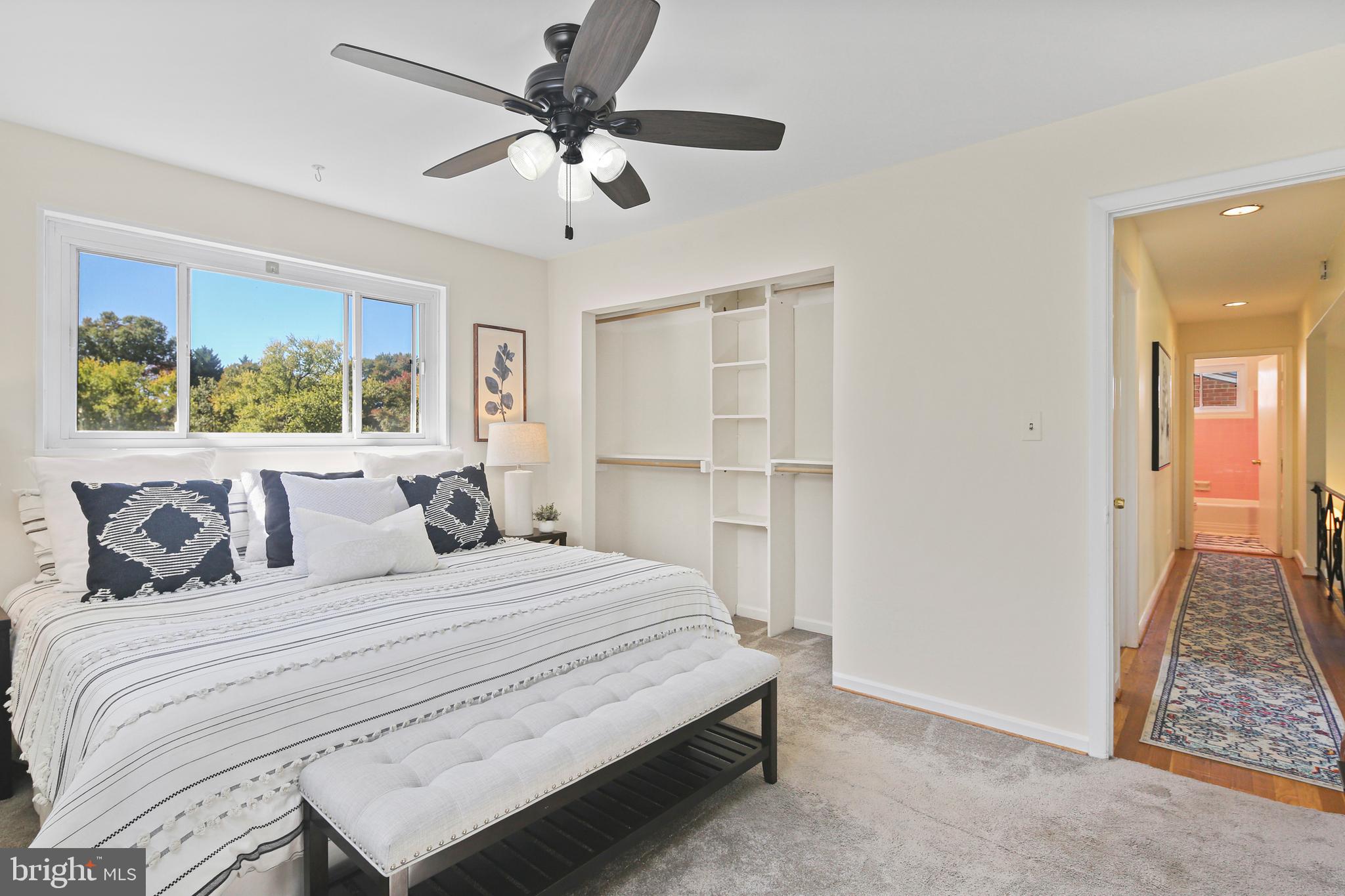12910 Crisfield Road Silver Spring, MD 20906 - Photo 15 of 30 a bedroom with a large bed and a chandelier