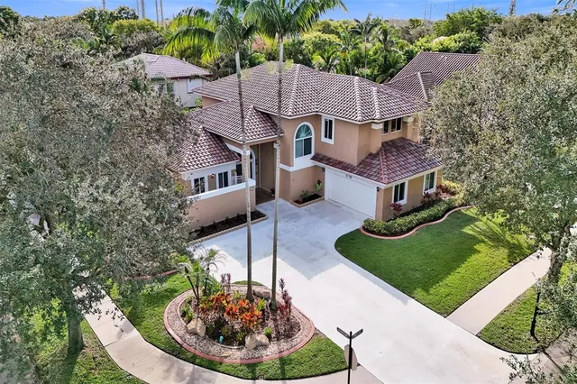 a aerial view of a house with a yard table and chairs