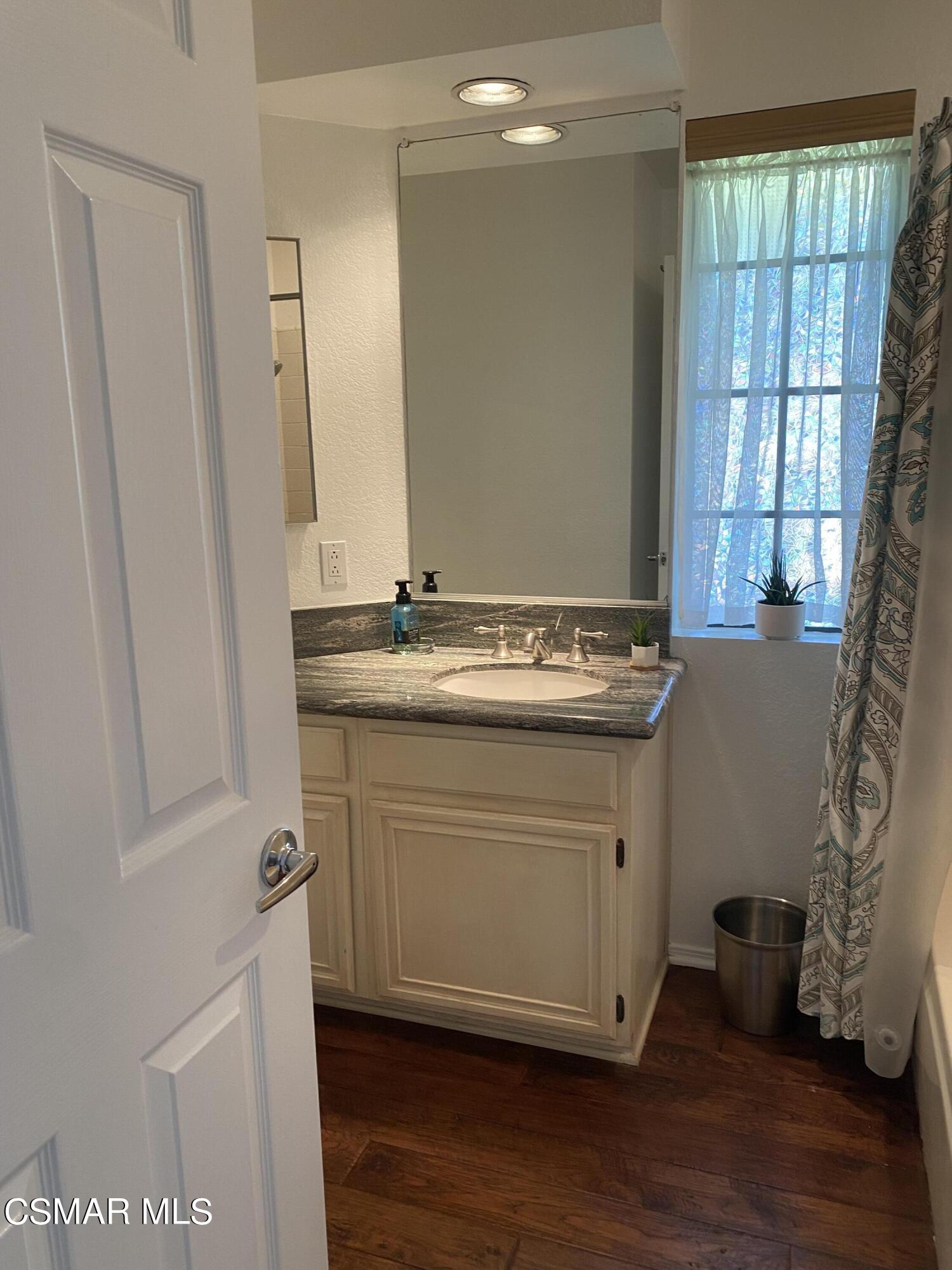 801 Congressional Road Simi Valley, CA 93065 - Photo 13 of 22 a view of bathroom with a sink mirror and wooden floor