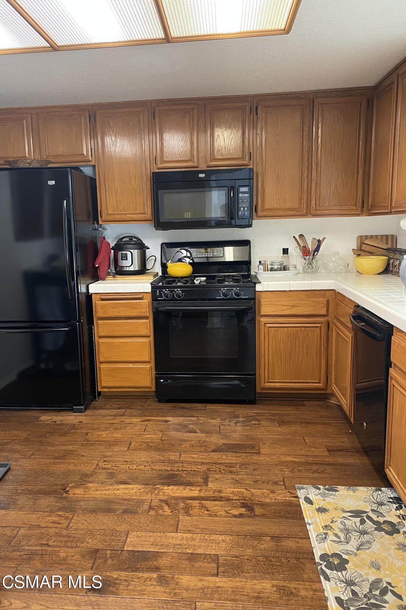 801 Congressional Road Simi Valley, CA 93065 - Photo 4 of 22 a kitchen with stainless steel appliances granite countertop a sink stove and refrigerator