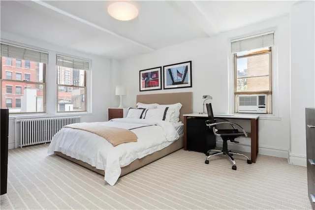 a bedroom with a bed and a table