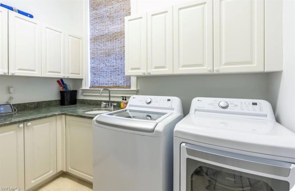 428 Rudder Road Naples, FL 34102 - Photo 49 of 49 Laundry area with washer and clothes dryer and cabinet space