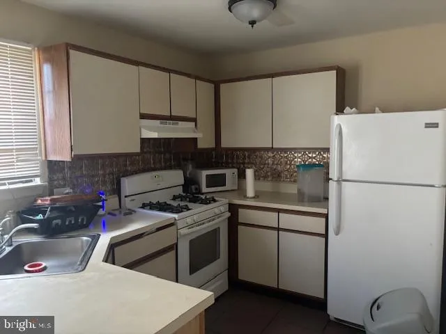 a kitchen with a sink a stove and refrigerator