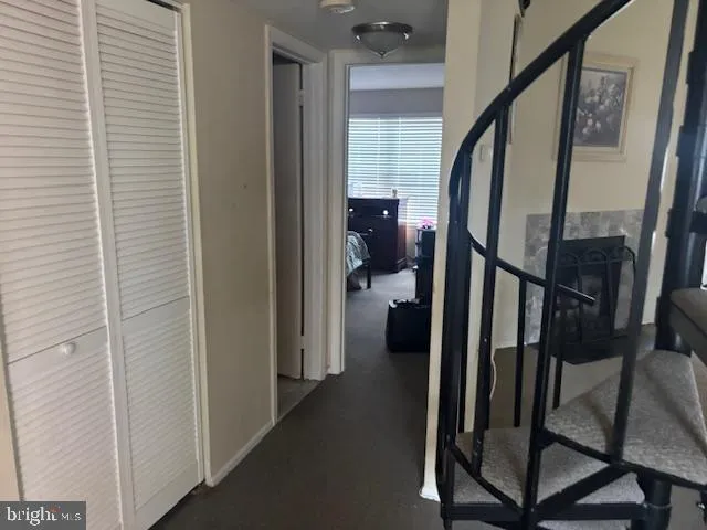 a view of a hallway with wooden floor and stairs