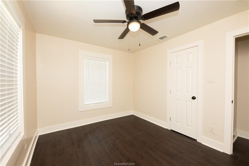 535 Husk Somerville, TX 77879 - Photo 3 of 9 an empty room with wooden floor fan and windows