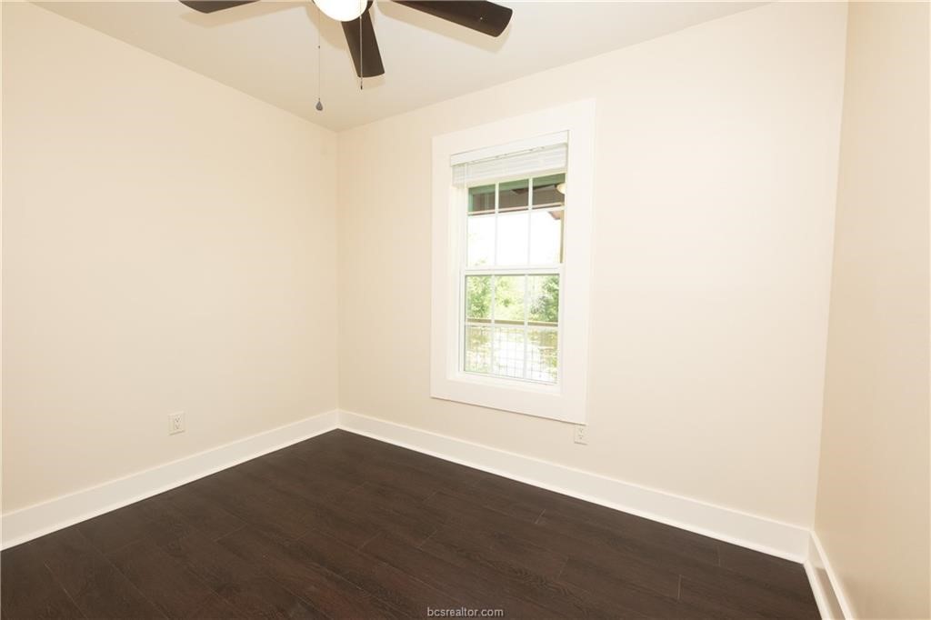 535 Husk Somerville, TX 77879 - Photo 4 of 9 an empty room with wooden floor fan and windows