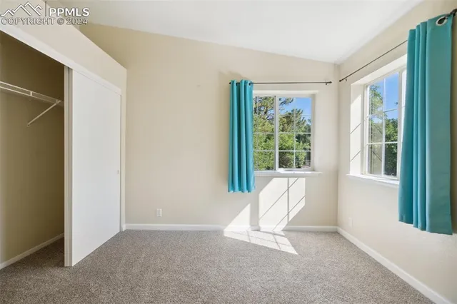 a view of an empty room with large windows
