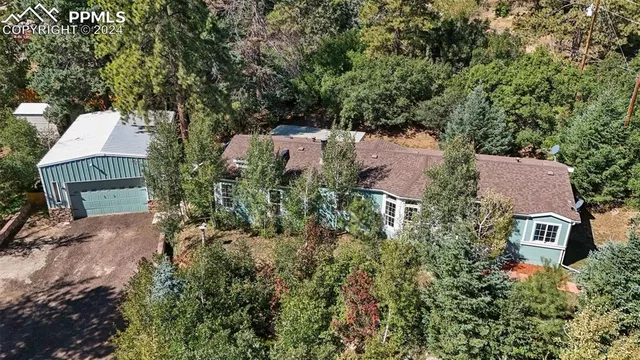 an aerial view of a house with a yard basket ball court and outdoor seating
