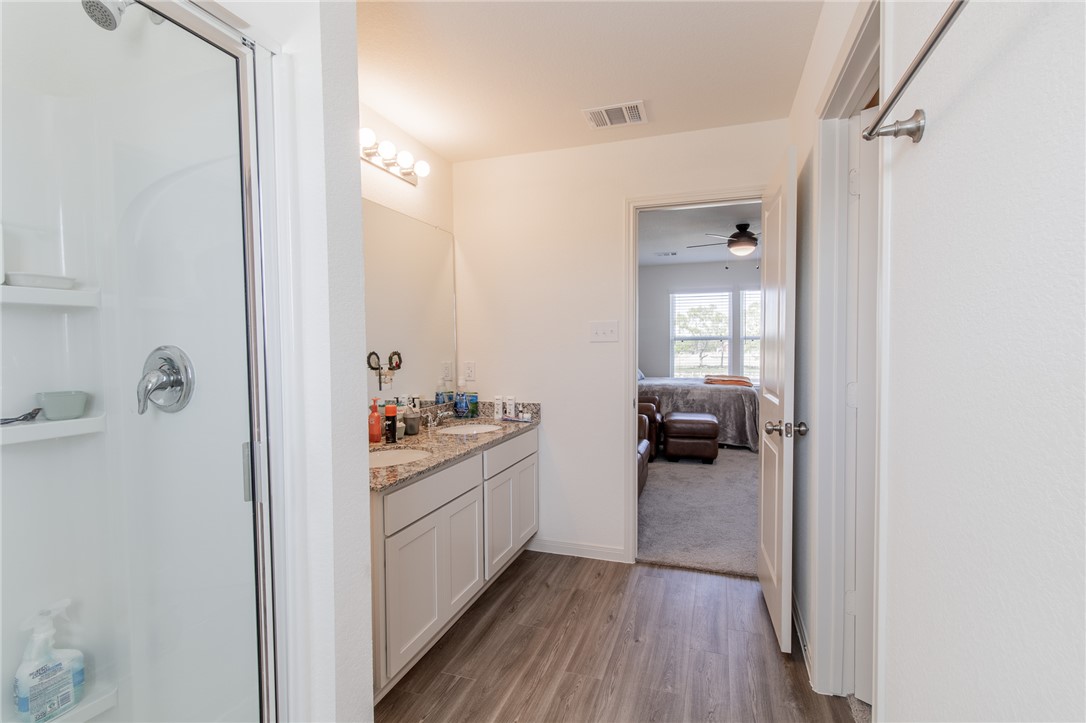 6029 Toby Bend Bryan, TX 77807 - Photo 17 of 25 a kitchen with a sink and wooden floor