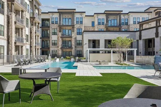 a view of a patio with table and chairs