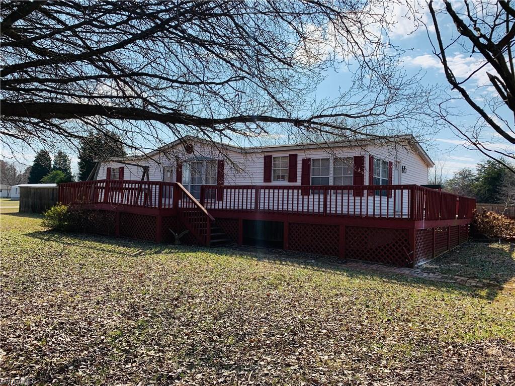 216 Price Mill Road Summerfield, NC 27358 - Photo 1 of 10 Vinyl siding, partially fenced. Deck needs work.