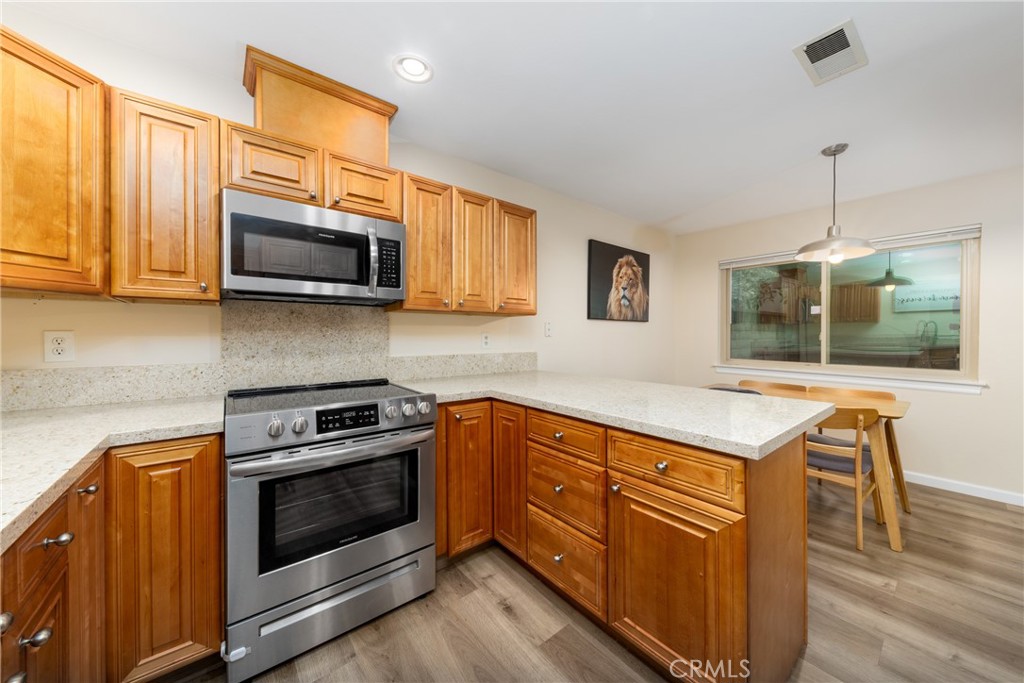 2760 Monroe Street Riverside, CA 92504 - Photo 11 of 21 a kitchen with stainless steel appliances granite countertop a stove and a microwave