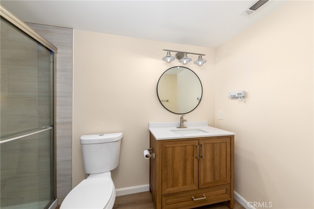 2760 Monroe Street Riverside, CA 92504 - Photo 18 of 21 a bathroom with a toilet a sink and a mirror