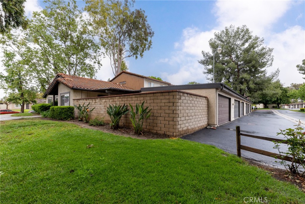 2760 Monroe Street Riverside, CA 92504 - Photo 3 of 21 a view of a house with a yard potted plants and large tree