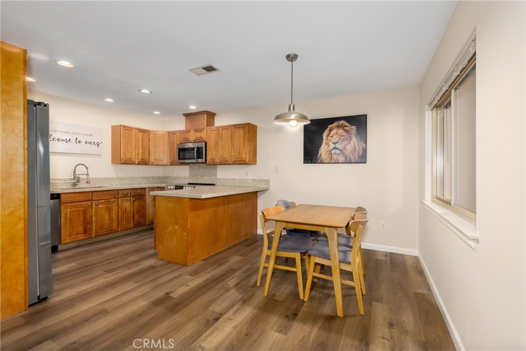 2760 Monroe Street Riverside, CA 92504 - Photo 7 of 21 a living room with stainless steel appliances kitchen island granite countertop furniture wooden floor and a window