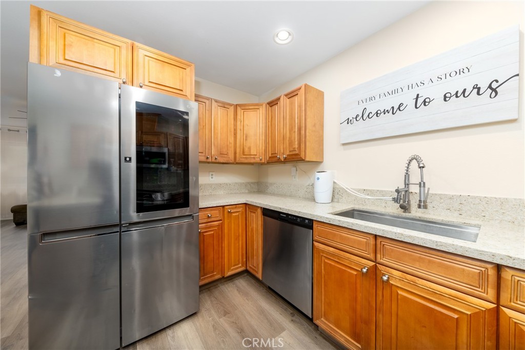 2760 Monroe Street Riverside, CA 92504 - Photo 9 of 21 a kitchen with stainless steel appliances granite countertop a refrigerator a sink and dishwasher
