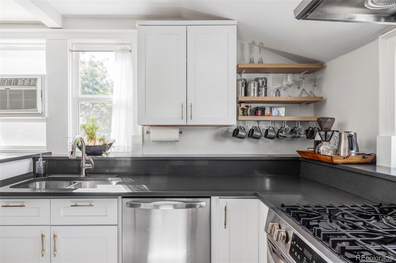 1035 East 10th Avenue, Unit 6 Denver, CO 80218 - Photo 14 of 32 a kitchen with stainless steel appliances granite countertop a sink stove and cabinets