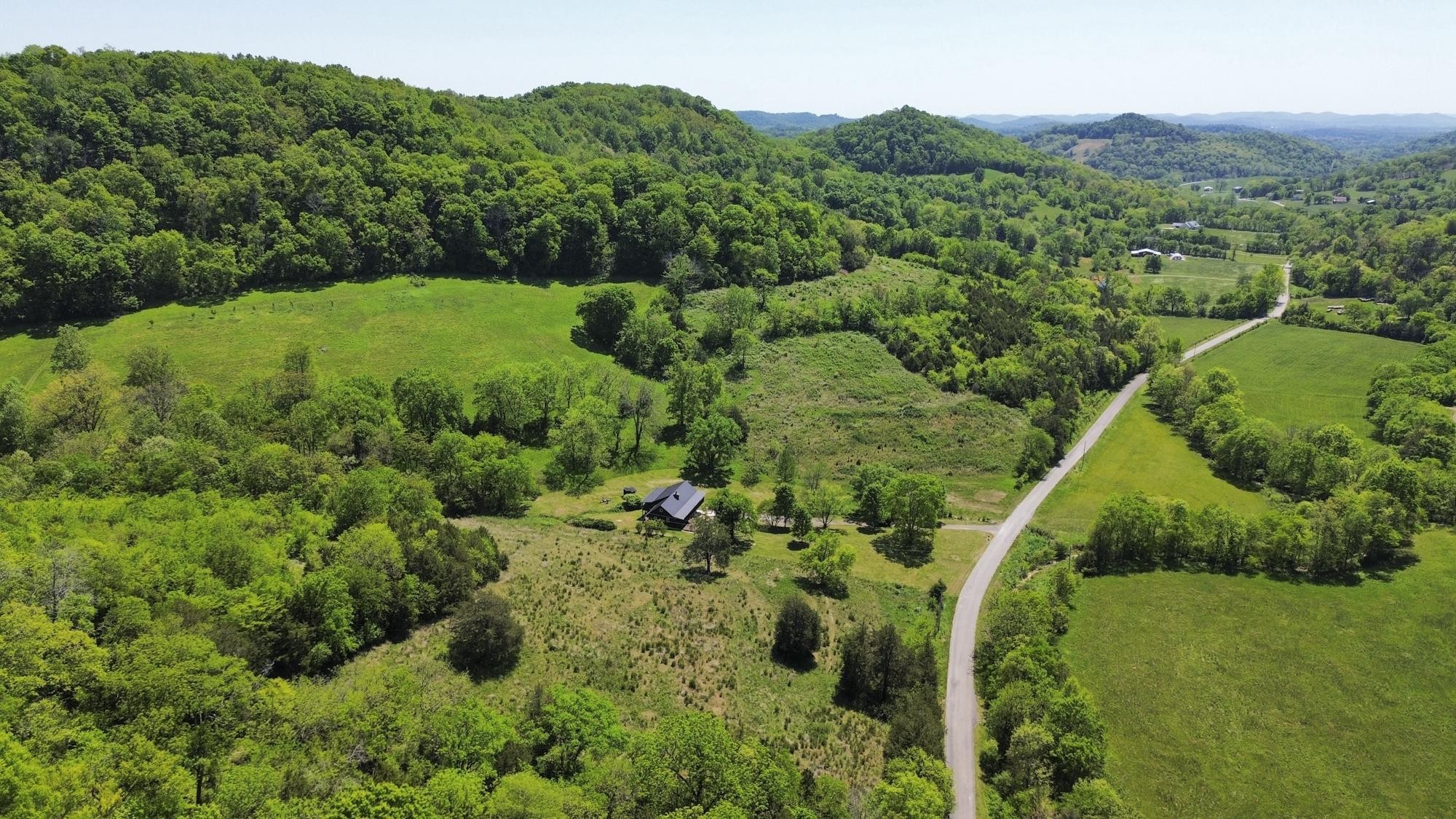 1370 Dog Branch Road Hartsville, TN 37074 - Photo 46 of 60 a view of a lush green forest with trees and some houses