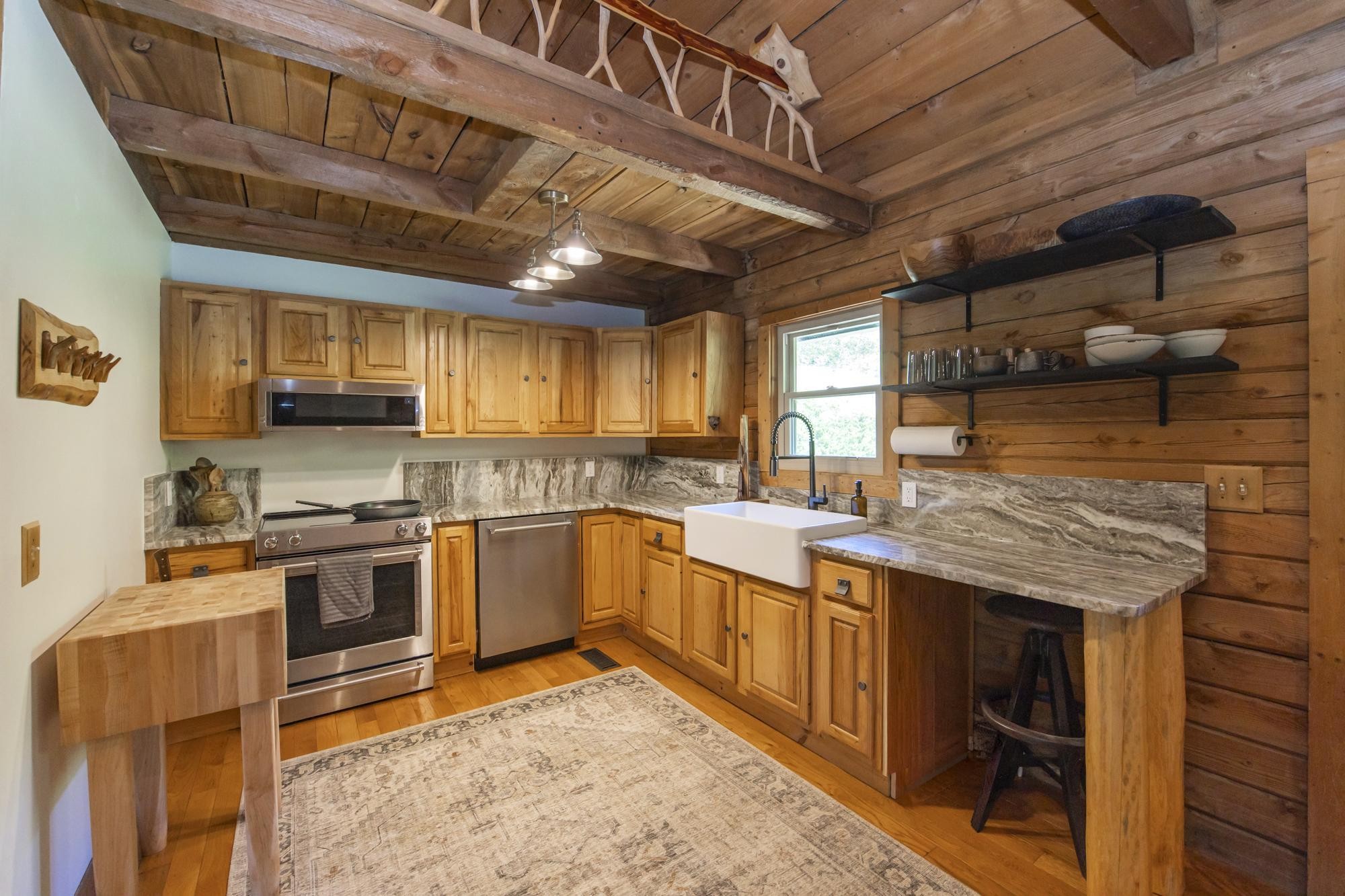 1370 Dog Branch Road Hartsville, TN 37074 - Photo 8 of 60 a kitchen with stainless steel appliances granite countertop a stove a sink and a microwave