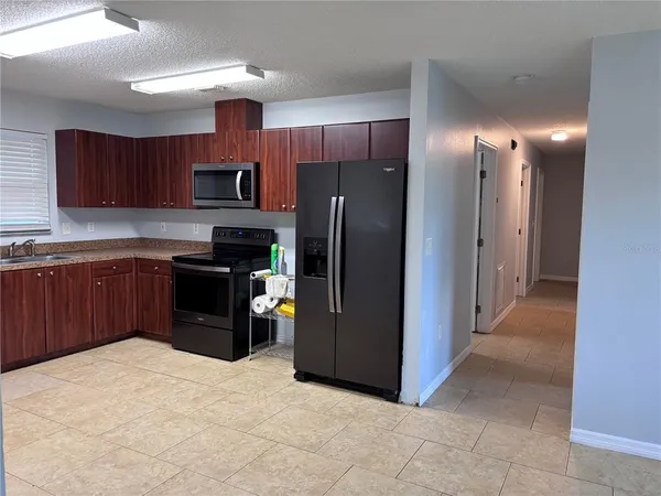 a kitchen with stainless steel appliances granite countertop a refrigerator and a sink