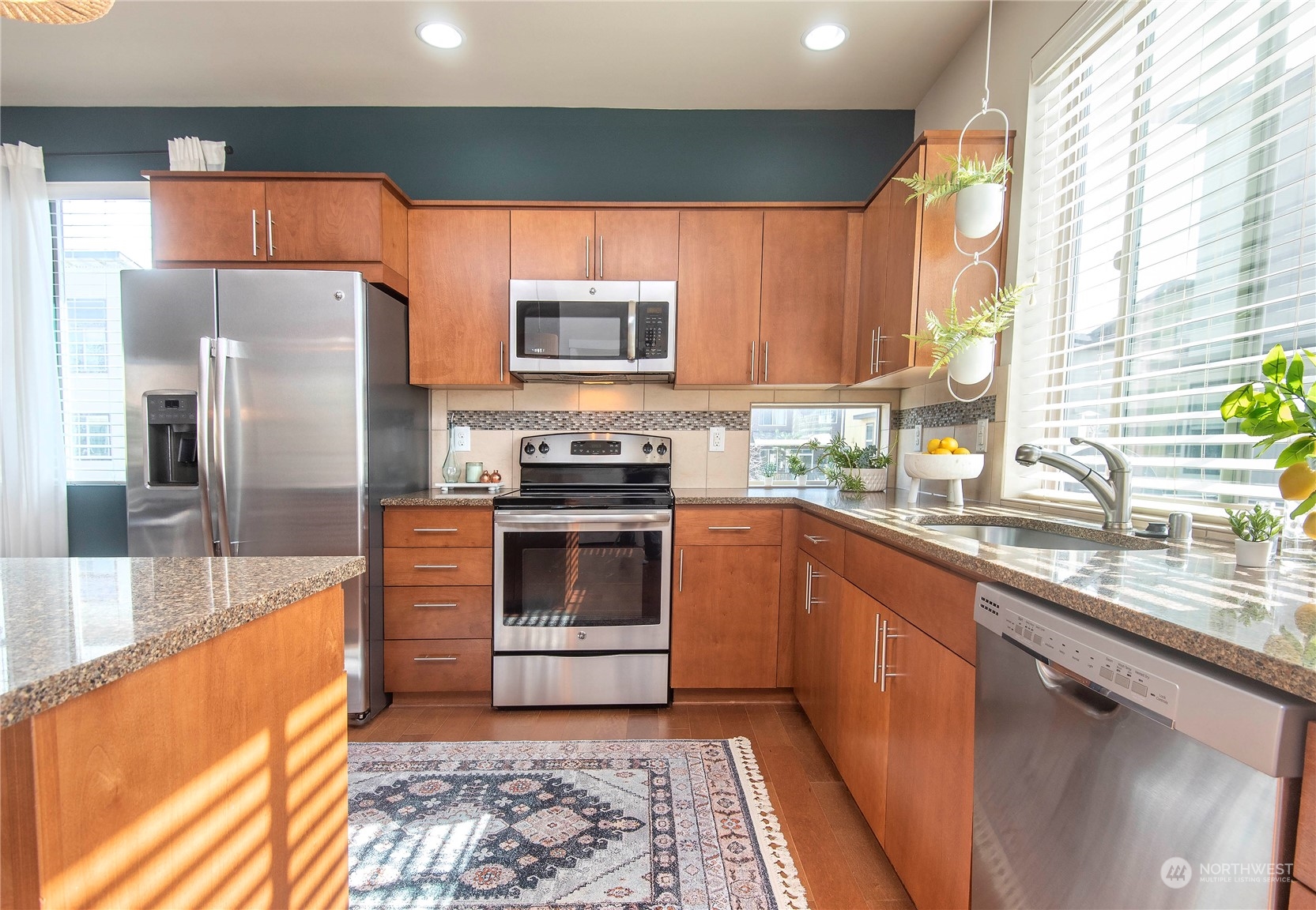 4525 Northeast 3rd Lane Renton, WA 98059 - Photo 7 of 26 a kitchen with stainless steel appliances wooden cabinets a stove and a sink