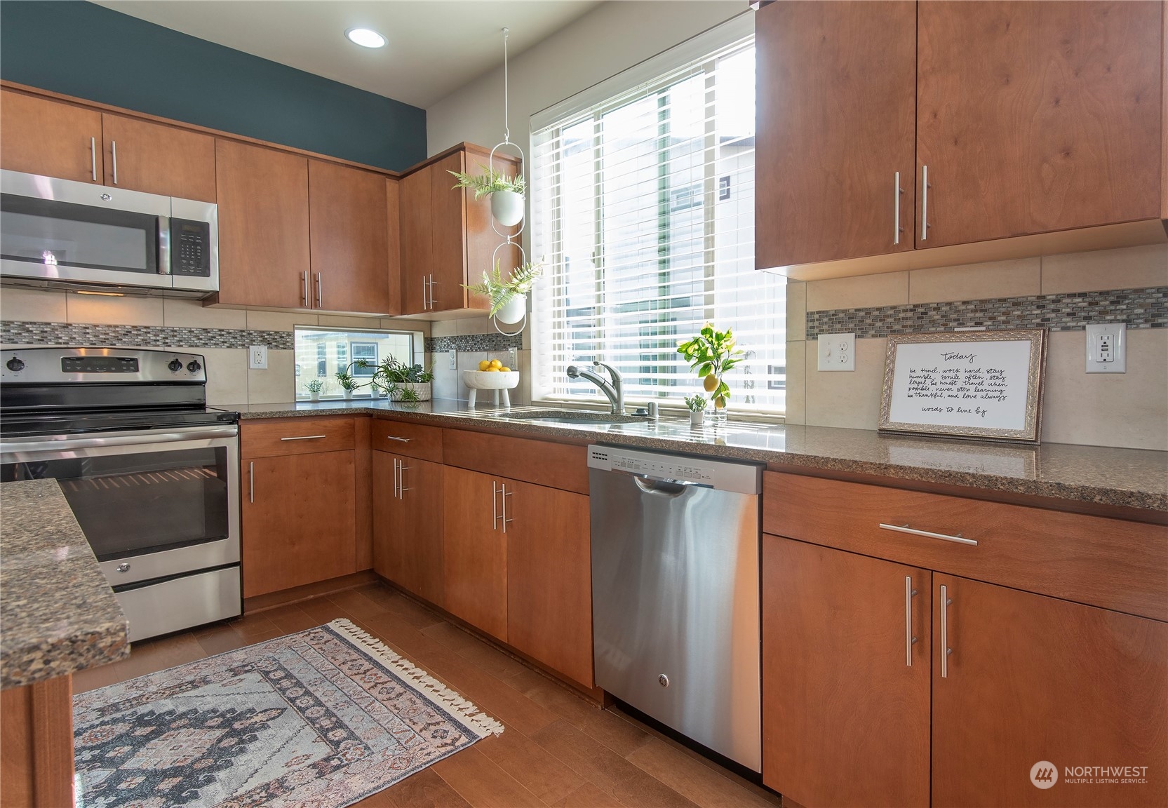 4525 Northeast 3rd Lane Renton, WA 98059 - Photo 8 of 26 a kitchen with stainless steel appliances granite countertop a stove a sink and a microwave