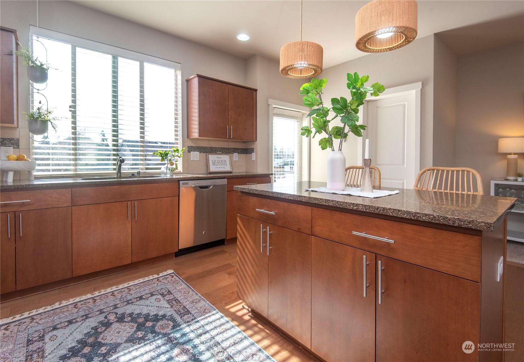 4525 Northeast 3rd Lane Renton, WA 98059 - Photo 9 of 26 a kitchen with stainless steel appliances granite countertop sink a window cabinets and wooden floor