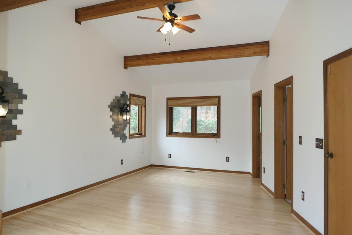 1249 Jordan Hills Loop Chapel Hill, NC 27517 - Photo 16 of 42 an empty room with windows and fan
