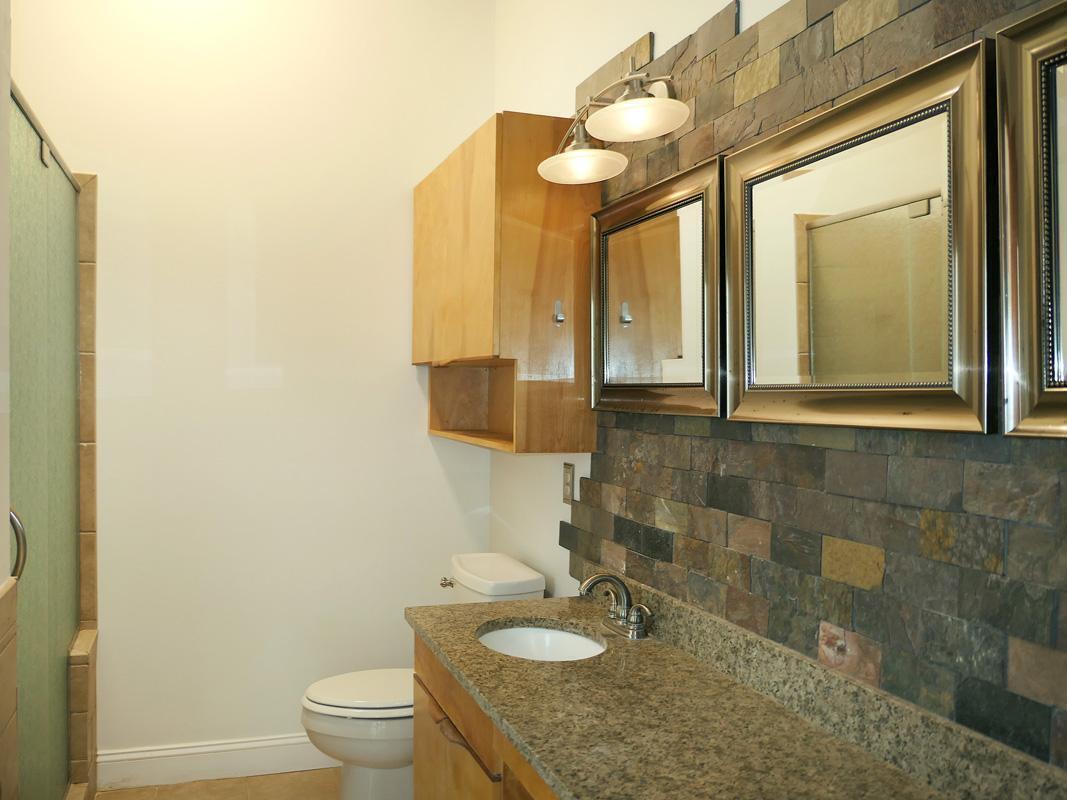 1249 Jordan Hills Loop Chapel Hill, NC 27517 - Photo 19 of 42 a bathroom with a granite countertop sink a toilet and a mirror