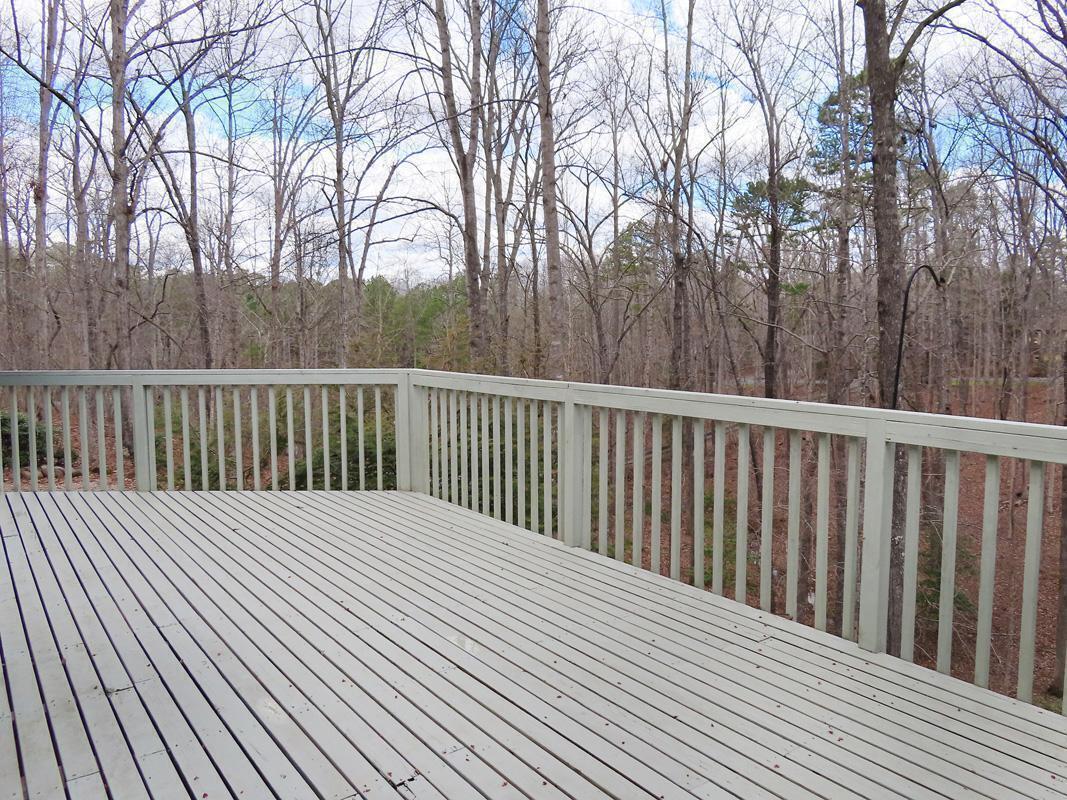 1249 Jordan Hills Loop Chapel Hill, NC 27517 - Photo 31 of 42 a balcony with wooden floor and trees