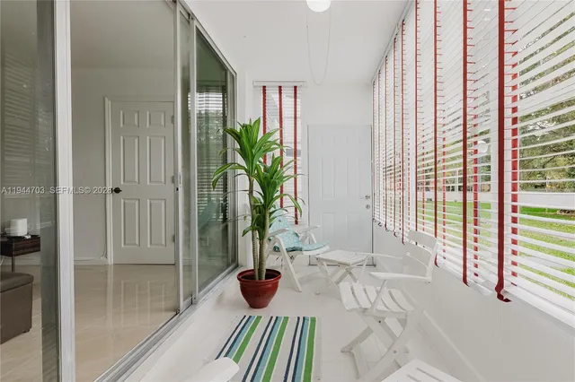 a view of a living room and a window and potted plants