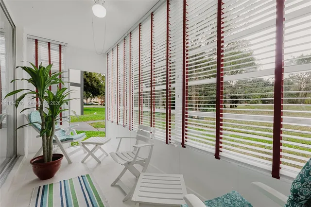 a view of front door with potted plants