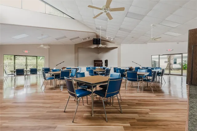 a view of a dining room with furniture wooden floor and chandelier