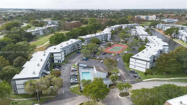 an aerial view of residential houses with outdoor space and river