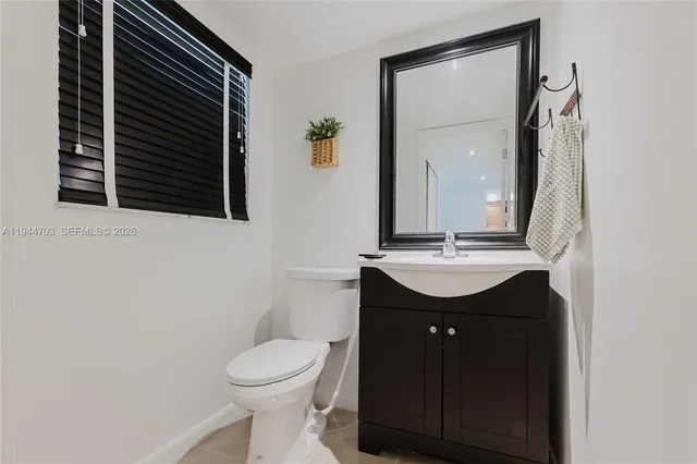 a bathroom with a sink a toilet and mirror