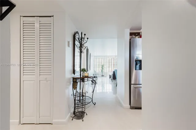 an entryway with a table and chairs