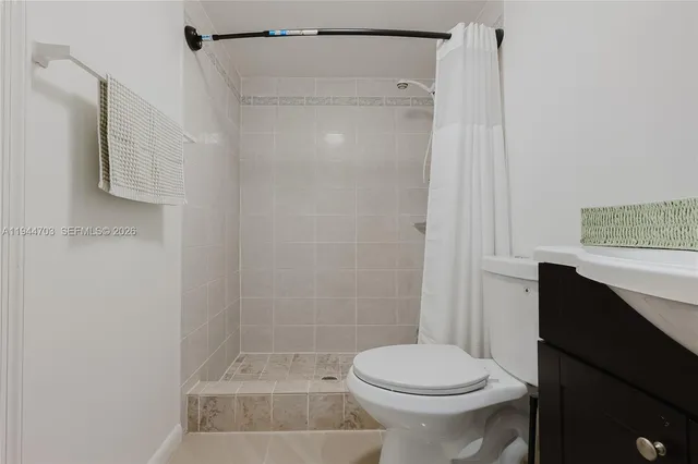 a bathroom with a shower and a toilet