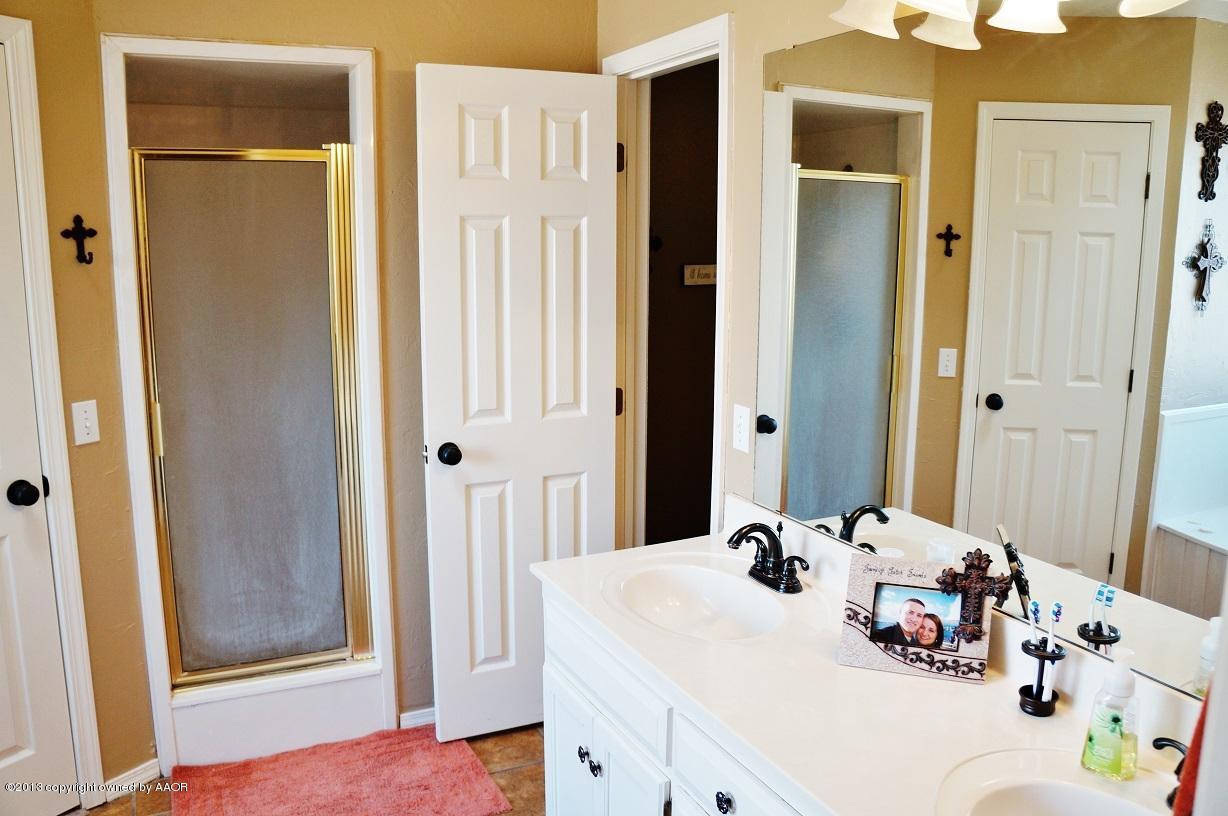 8012 Claret Street Amarillo, TX 79110 - Photo 18 of 25 a bathroom with a sink and a mirror