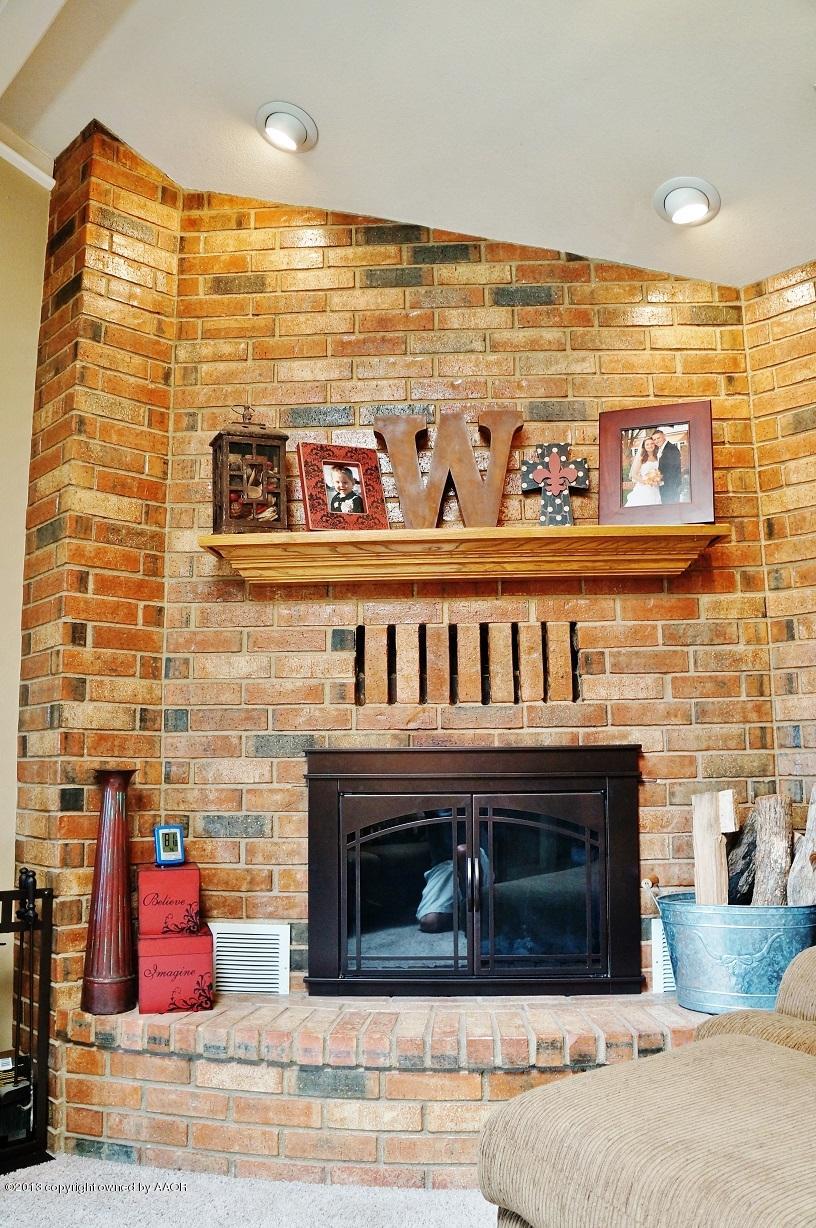 8012 Claret Street Amarillo, TX 79110 - Photo 5 of 25 a front door with fireplace