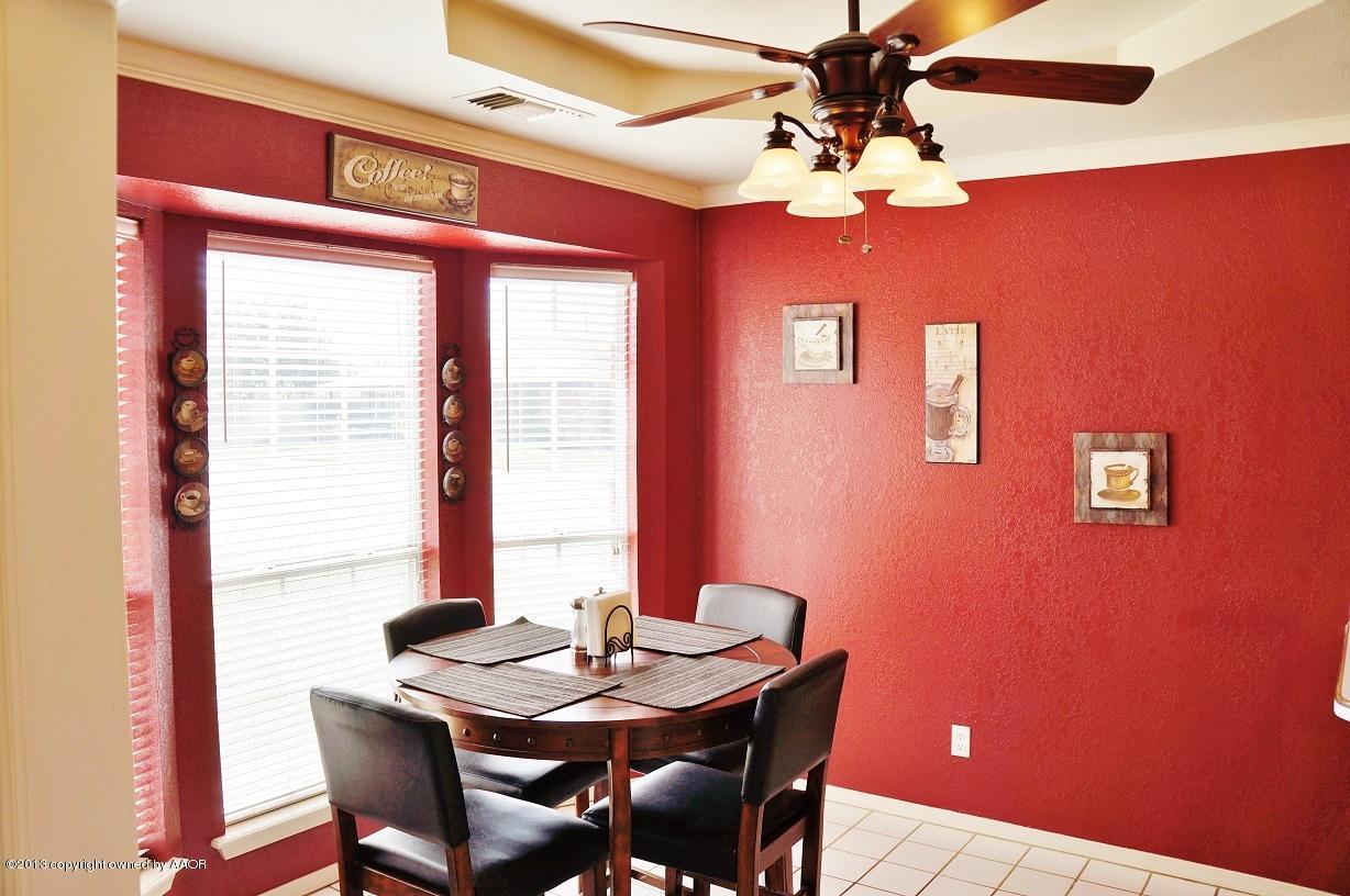 8012 Claret Street Amarillo, TX 79110 - Photo 7 of 25 a view of a dining room with furniture and chandelier