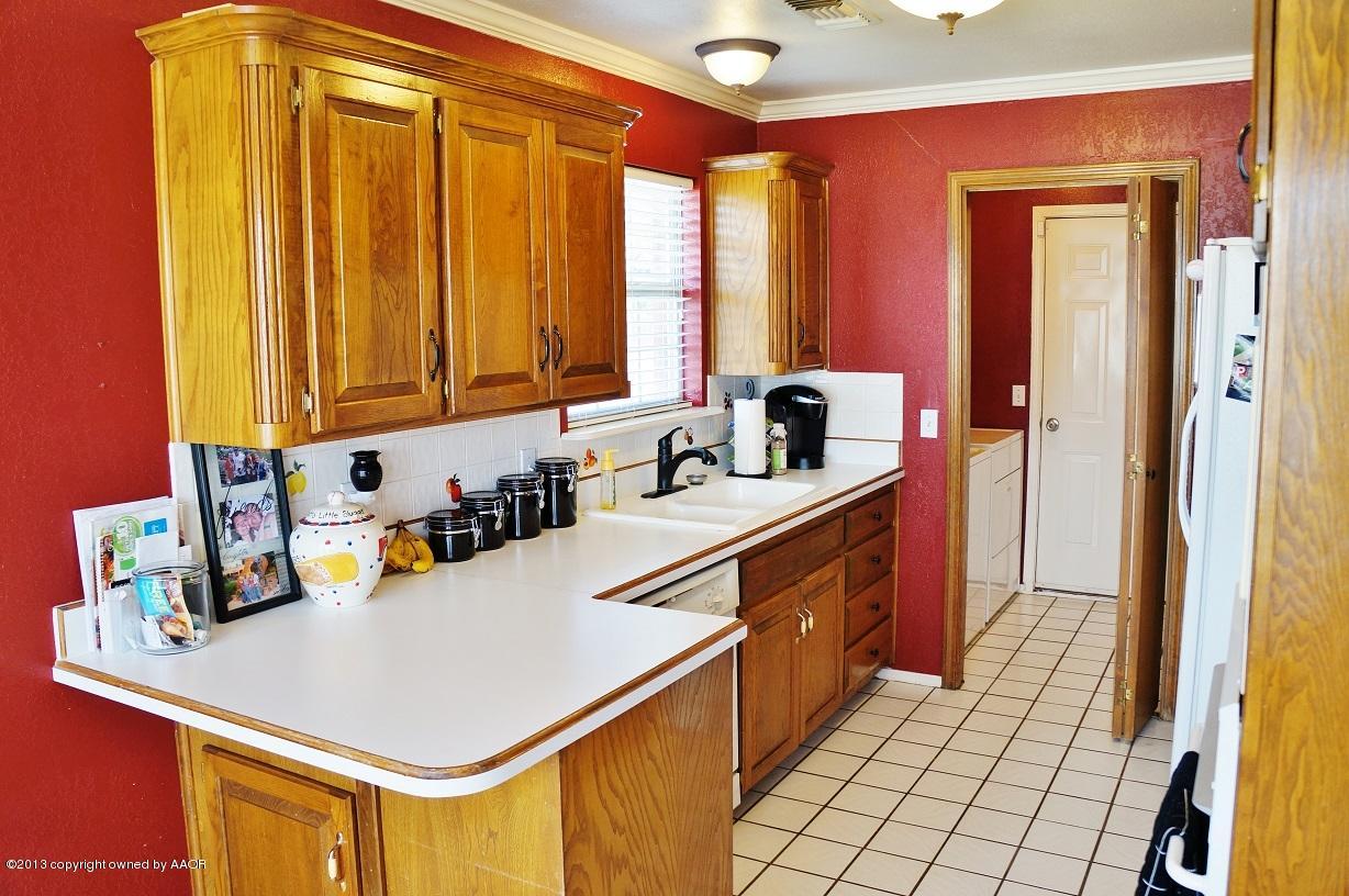 8012 Claret Street Amarillo, TX 79110 - Photo 8 of 25 a kitchen with a sink a stove and cabinets