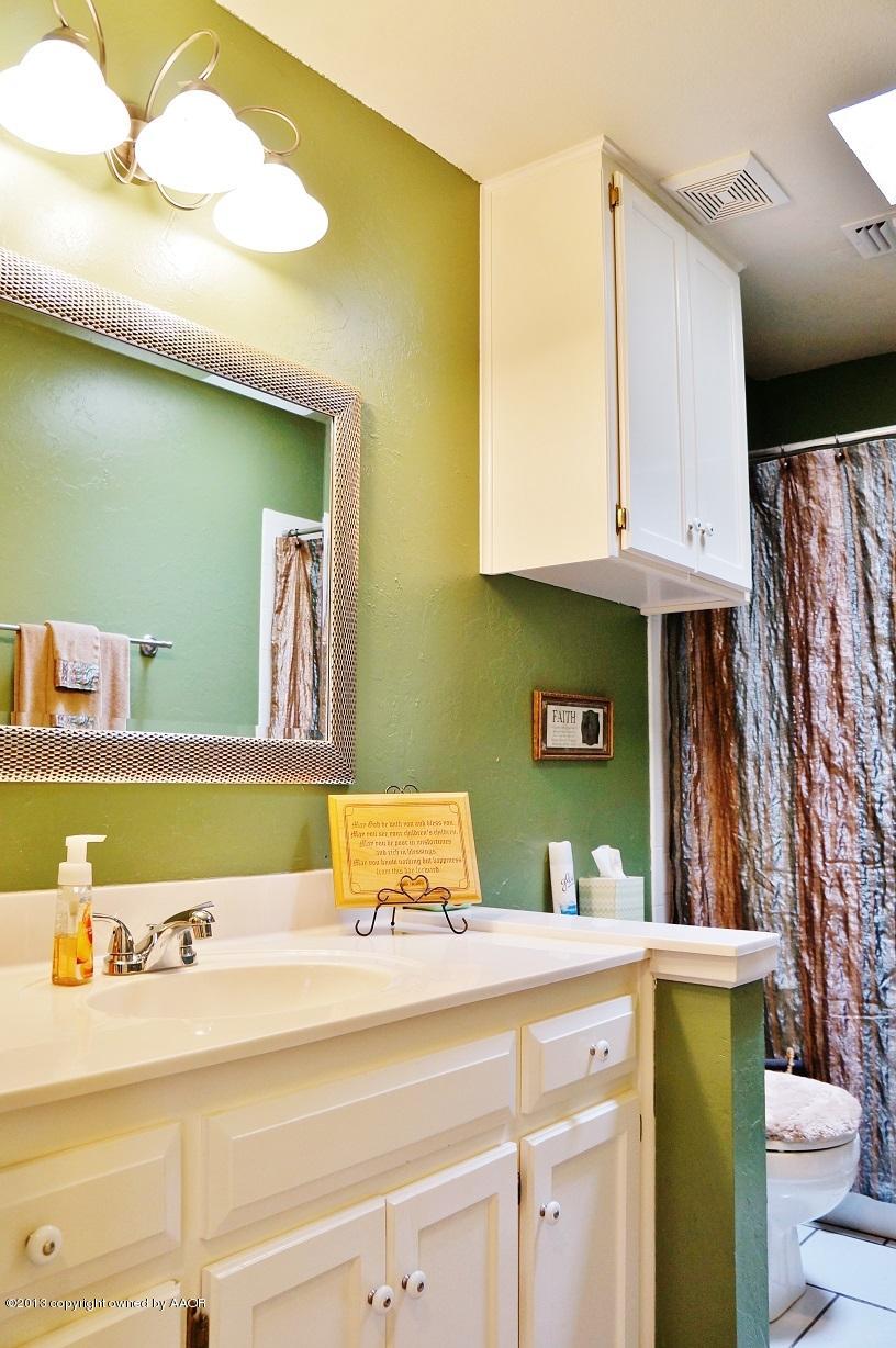 8012 Claret Street Amarillo, TX 79110 - Photo 10 of 25 a bathroom with a sink and a mirror