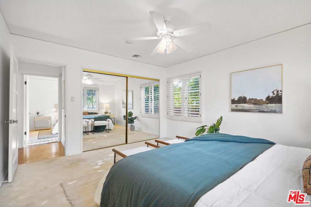 900 West Kenneth Road Glendale, CA 91202 - Photo 29 of 46 a bedroom with a large bed and a chandelier